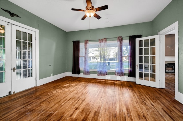 interior space with ceiling fan, french doors, and wood-type flooring