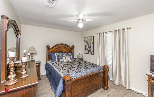 bedroom with light hardwood / wood-style flooring and ceiling fan