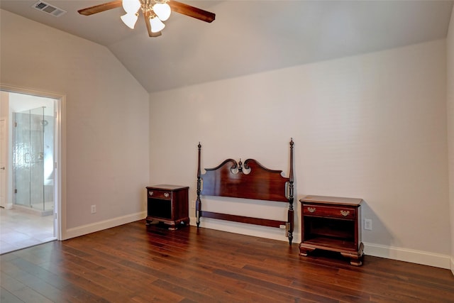 bedroom with dark hardwood / wood-style floors, ceiling fan, lofted ceiling, and ensuite bath