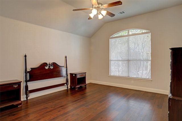 bedroom featuring ceiling fan, dark wood-type flooring, and vaulted ceiling