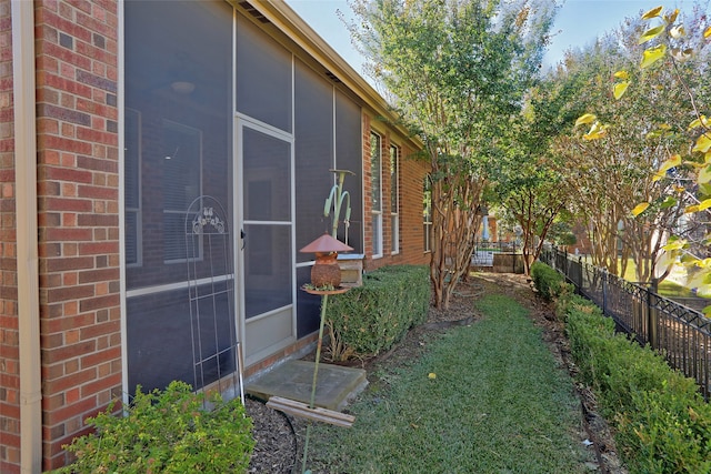 view of side of home with a sunroom