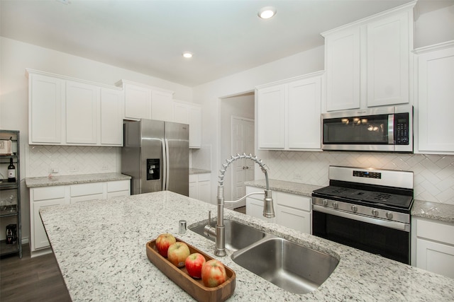 kitchen featuring sink, stainless steel appliances, light stone counters, dark hardwood / wood-style flooring, and white cabinets