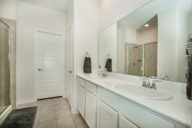 bathroom featuring tile patterned floors, vanity, and a shower with door