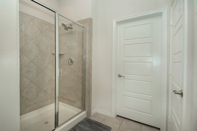 washroom featuring washing machine and dryer and light tile patterned flooring