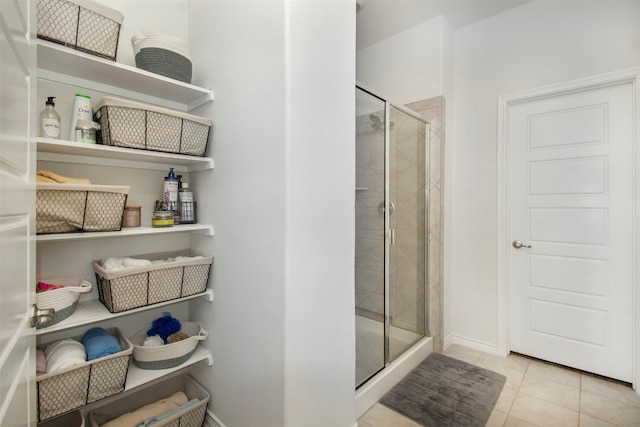 bathroom with tile patterned flooring and walk in shower