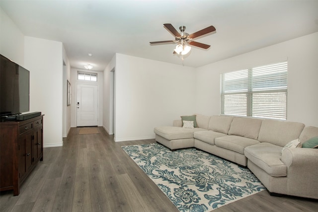 living room featuring hardwood / wood-style floors and ceiling fan