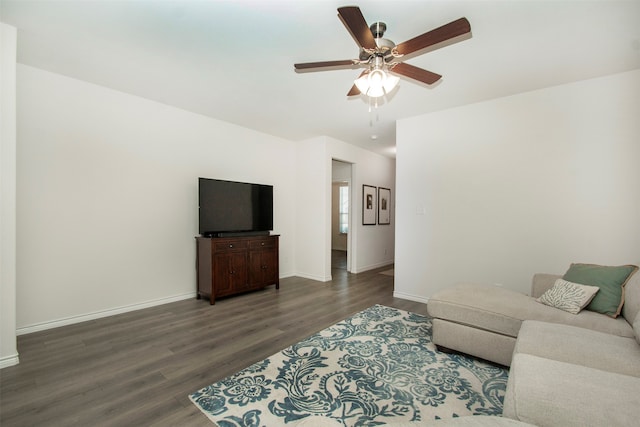 living room featuring dark hardwood / wood-style flooring and ceiling fan