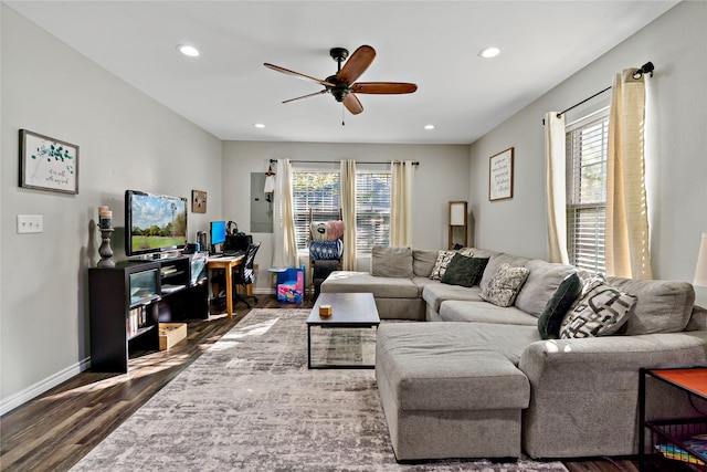 living room with ceiling fan, dark hardwood / wood-style flooring, and a wealth of natural light