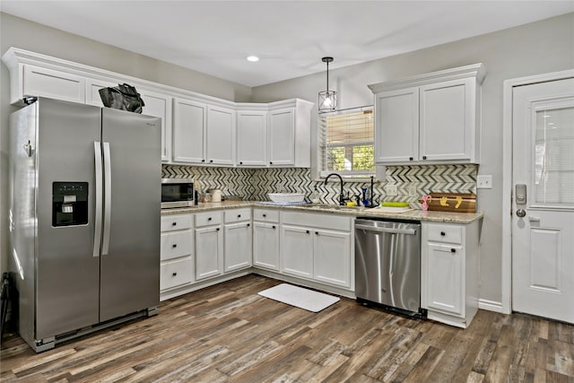 kitchen featuring white cabinets, appliances with stainless steel finishes, and dark wood-type flooring