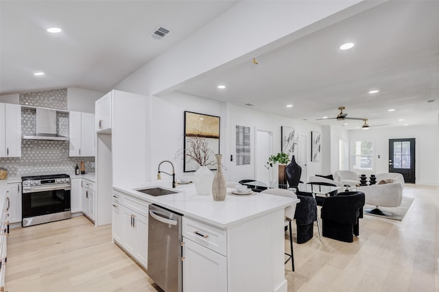 kitchen featuring white cabinets, stainless steel appliances, light hardwood / wood-style floors, and sink