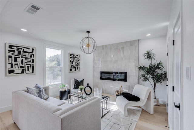 living room with light wood-type flooring and a fireplace