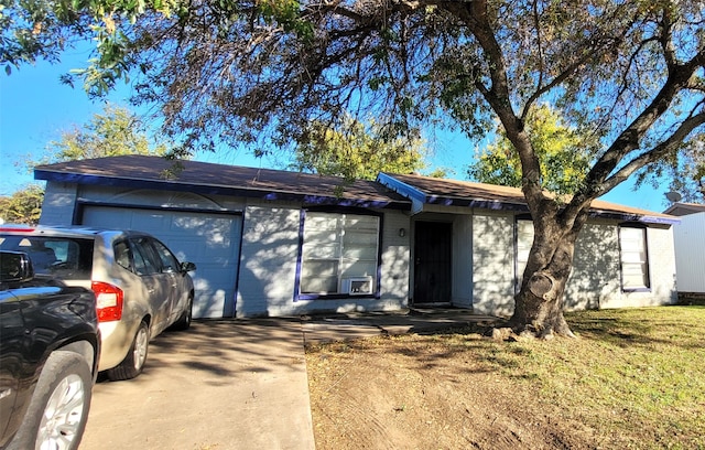 single story home with a garage and a front lawn