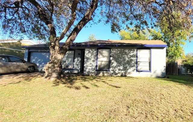 ranch-style house featuring a garage and a front yard