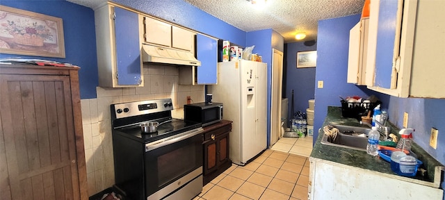 kitchen featuring backsplash, sink, a textured ceiling, appliances with stainless steel finishes, and light tile patterned flooring