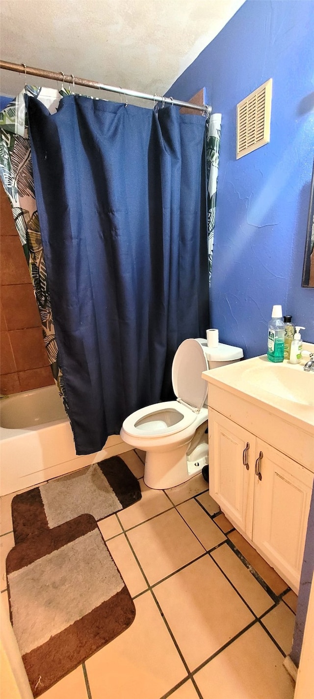 full bathroom featuring toilet, shower / bath combination with curtain, vanity, and tile patterned floors