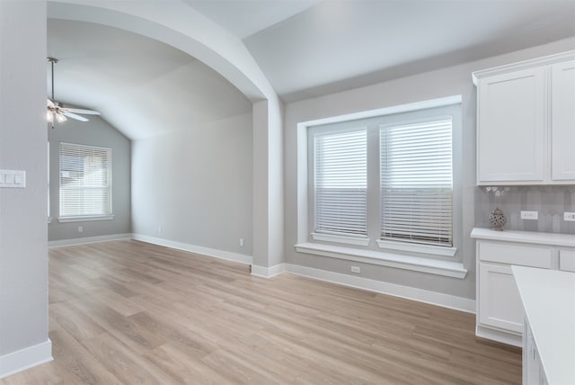 interior space with light hardwood / wood-style floors, ceiling fan, and lofted ceiling