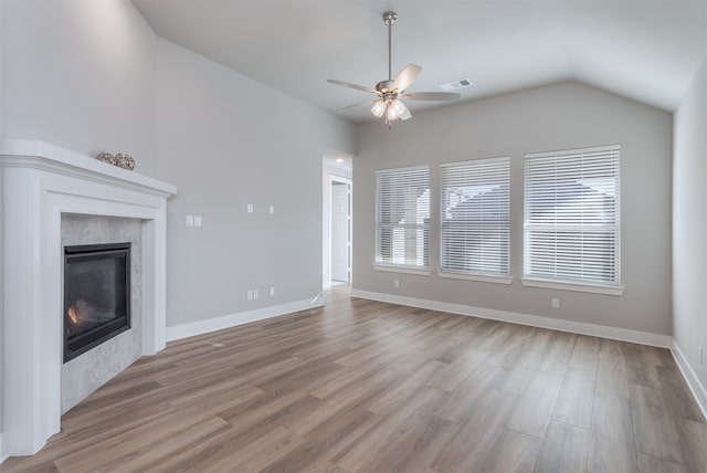 unfurnished living room featuring light hardwood / wood-style floors, vaulted ceiling, and ceiling fan