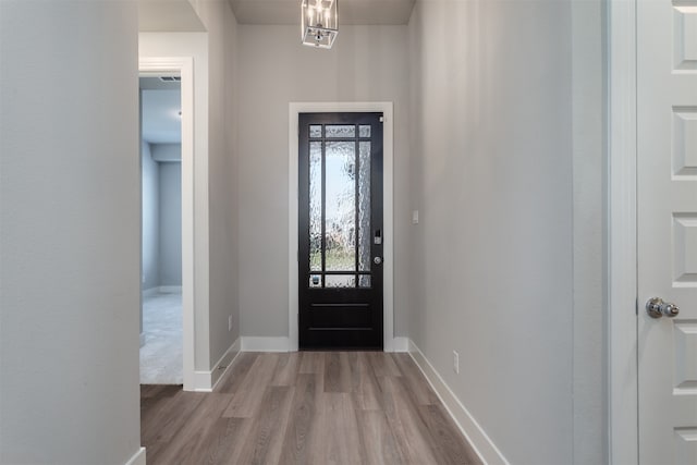 foyer featuring a notable chandelier and light wood-type flooring