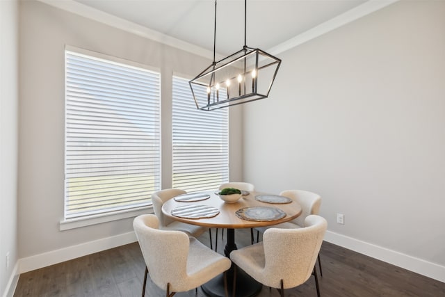 dining room featuring a chandelier, dark hardwood / wood-style floors, plenty of natural light, and crown molding