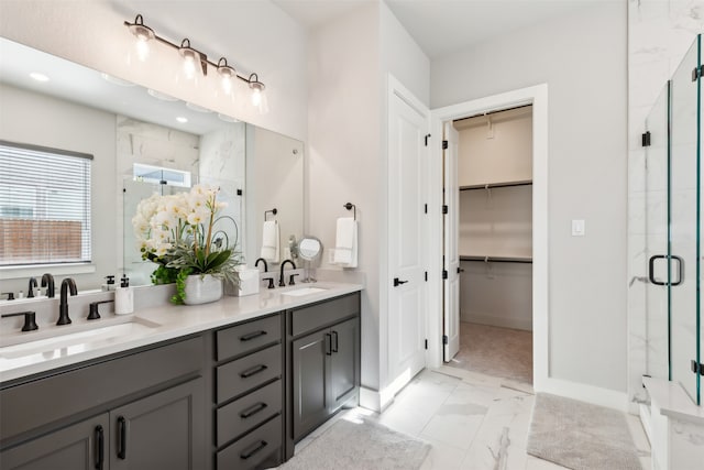 bathroom featuring vanity and a shower with door