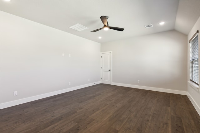 empty room with dark hardwood / wood-style floors, vaulted ceiling, and ceiling fan