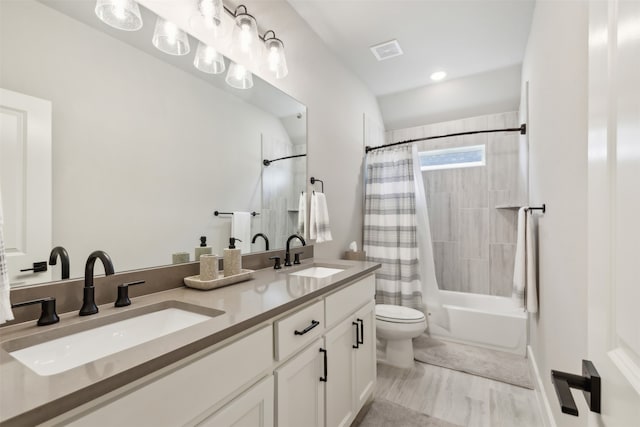 full bathroom with vanity, shower / bathtub combination with curtain, and toilet