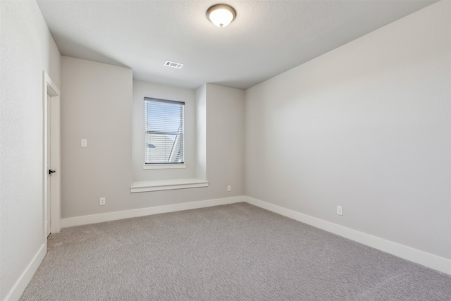 empty room featuring light colored carpet