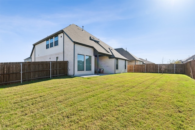 rear view of property with a lawn