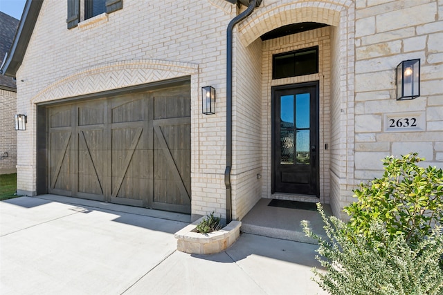 view of exterior entry with a garage