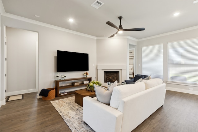 living room with ceiling fan, dark hardwood / wood-style flooring, and crown molding