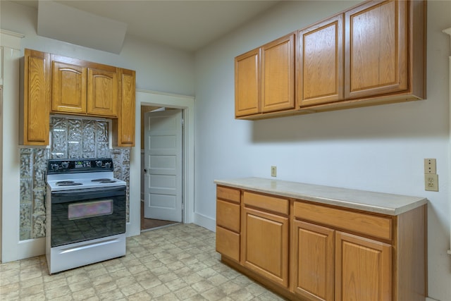 kitchen featuring white range with electric stovetop and decorative backsplash