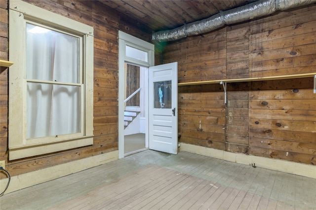 interior space with wood-type flooring, wooden ceiling, and wooden walls