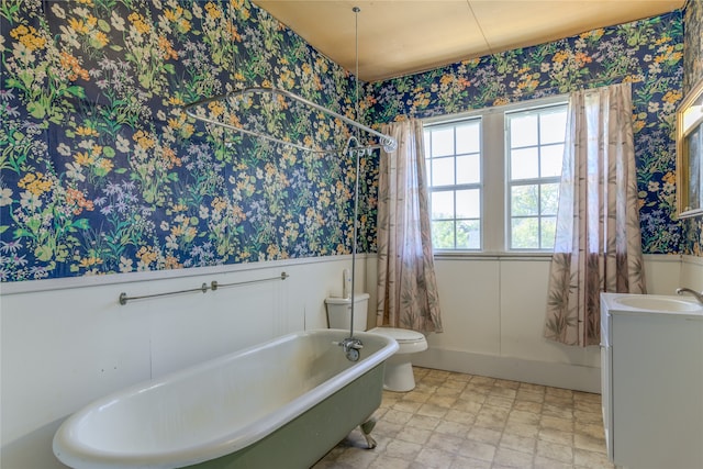 full bathroom featuring shower / bath combination with curtain, toilet, and sink