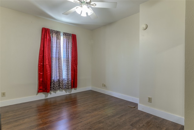 empty room featuring ceiling fan and dark wood-type flooring