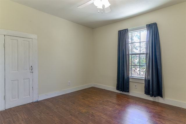 unfurnished room with ceiling fan and dark hardwood / wood-style flooring