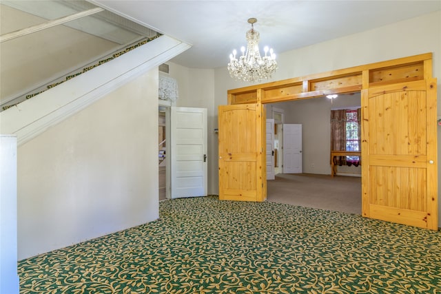 carpeted empty room with an inviting chandelier