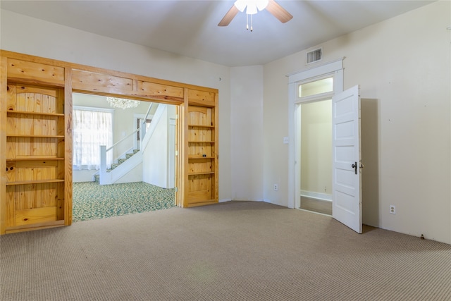 spare room featuring ceiling fan and carpet floors