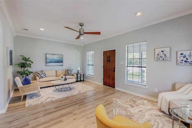 living room with crown molding, ceiling fan, and light wood-type flooring