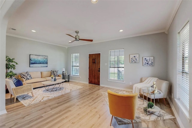 living room featuring ceiling fan, light hardwood / wood-style floors, and ornamental molding