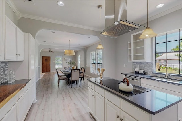 kitchen featuring white cabinets, ceiling fan, black electric cooktop, decorative light fixtures, and island exhaust hood