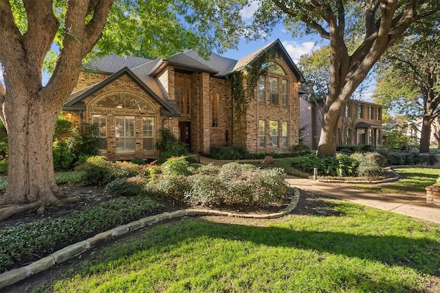 tudor house featuring a front lawn