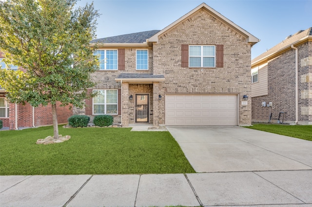 view of front of property with a garage and a front lawn