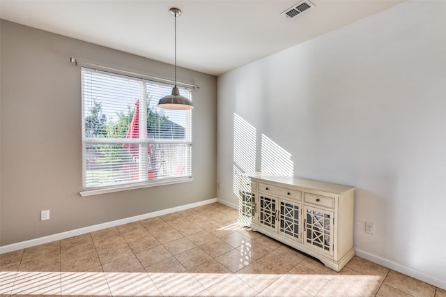 unfurnished dining area featuring light tile patterned floors and a wealth of natural light