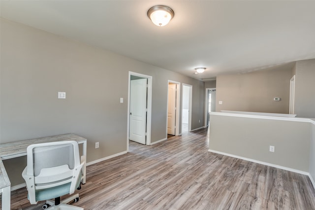 unfurnished office with light wood-type flooring