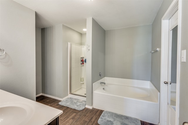 bathroom with vanity, plus walk in shower, and wood-type flooring