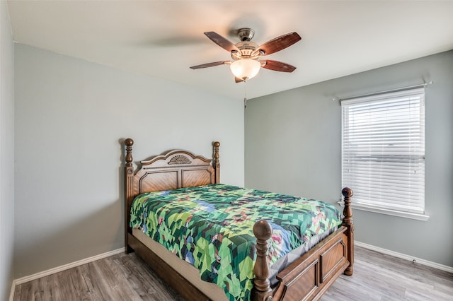 bedroom with ceiling fan and hardwood / wood-style flooring