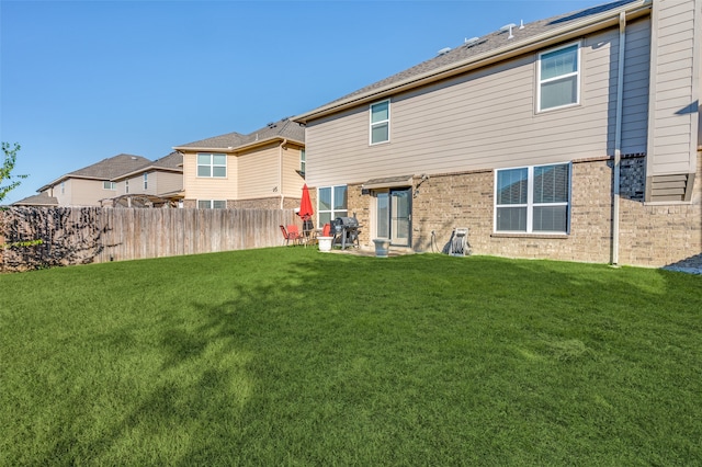 rear view of house featuring a lawn