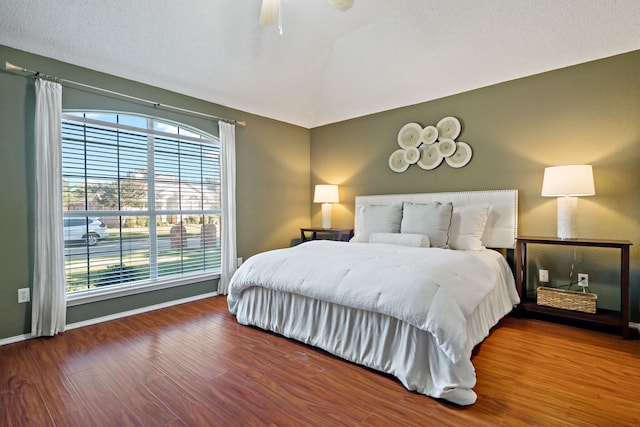 bedroom featuring a textured ceiling, hardwood / wood-style flooring, and ceiling fan