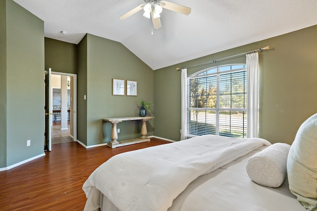 bedroom featuring a textured ceiling, ceiling fan, dark hardwood / wood-style flooring, and lofted ceiling