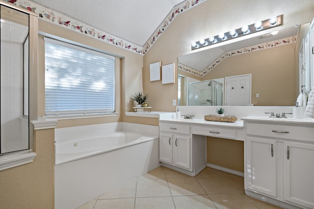 bathroom featuring tile patterned floors, vanity, a textured ceiling, vaulted ceiling, and separate shower and tub